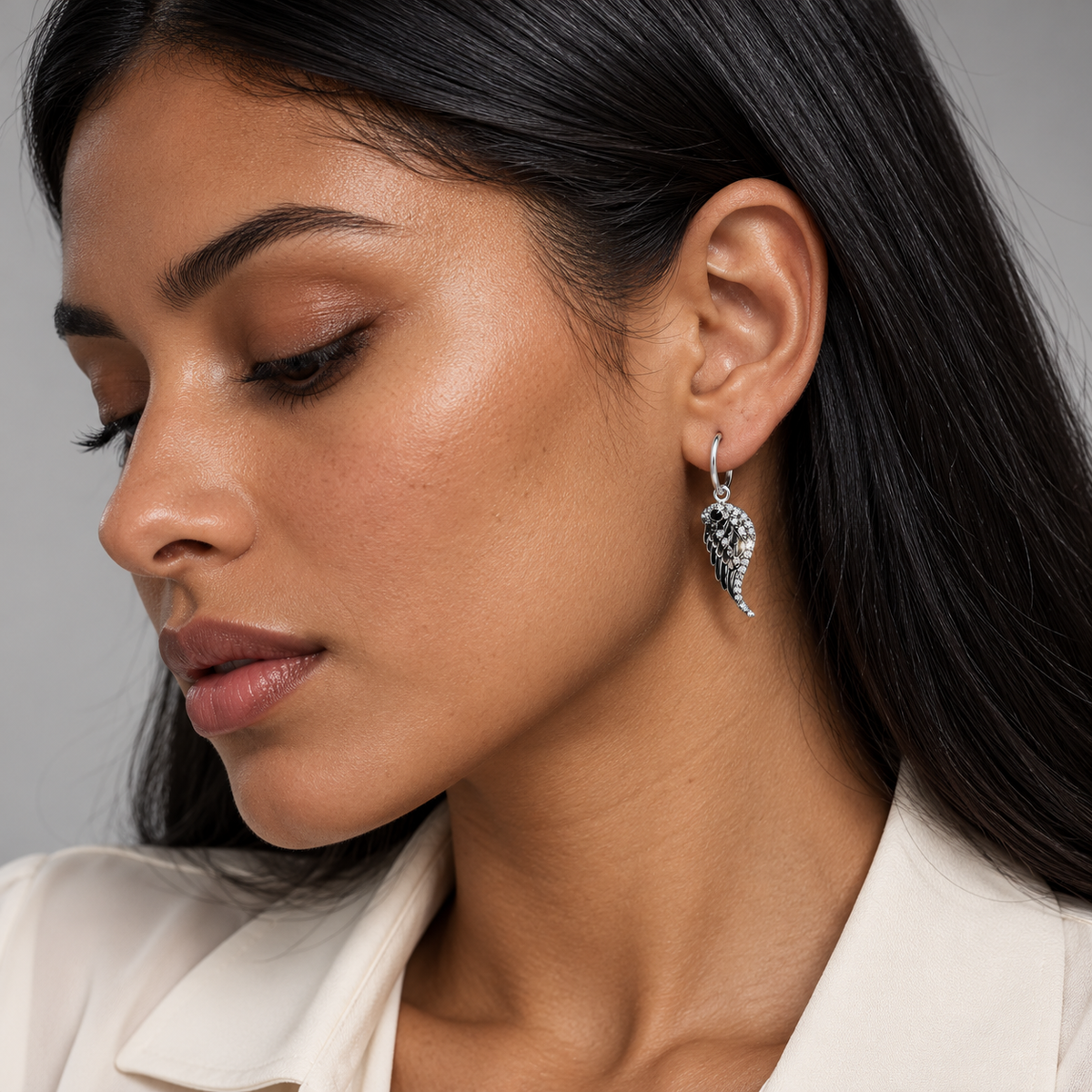 Sterling silver and cubic zirconia angel wing drop earrings